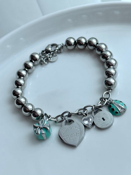 PULSERA BOLITAS CON DIJES