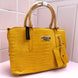 BOLSA BEBE AUBREY CROCO AMARILLA